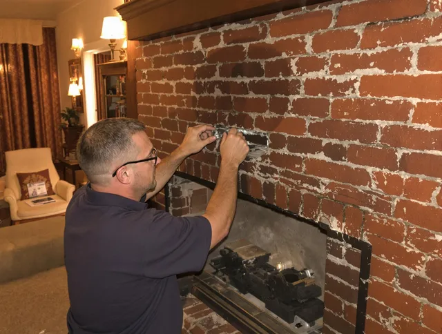 North Smithfield Chimney Sweep expert fixing a fireplace in North Smithfield, RI